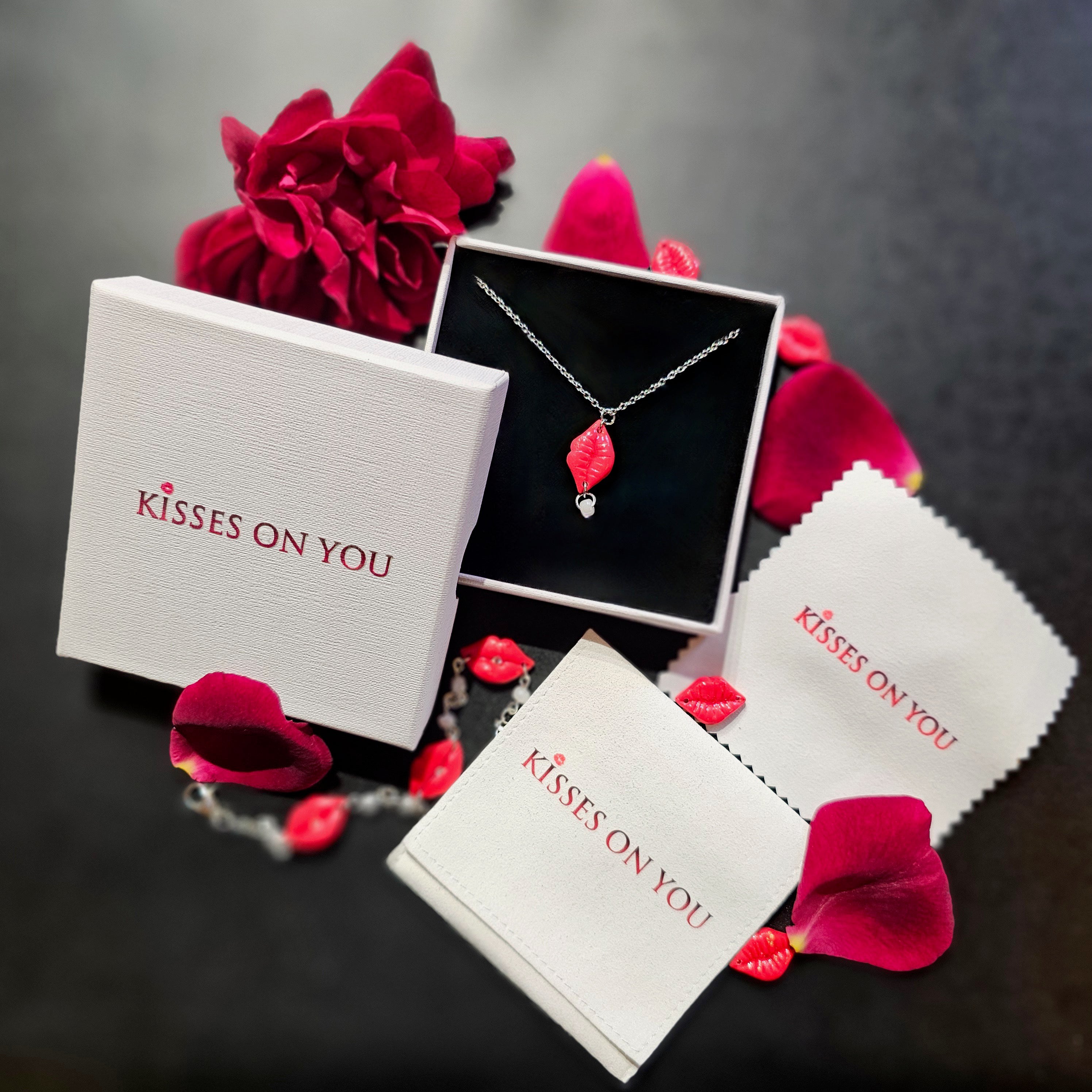 kisses on you home page image with red roses and polymer clay kiss pendant with kisses on you packaging